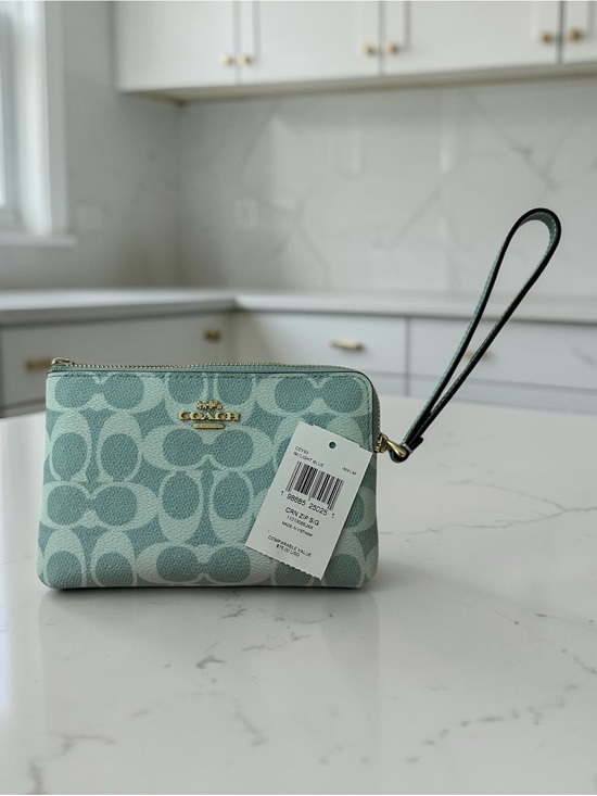 Coach Handbags - Coach Light Blue Signature Wristlet. New with tags